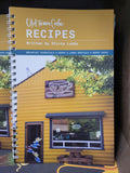 Spiral-bound cookbook titled 'Old Town Cafe Recipes' with a cover featuring a yellow building and cafe sign.