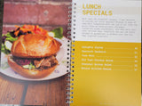 cookbook interior pages featuring a table of contents for lunch recipes, as well as a picture of a sandwich and salad.