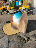 Ball cap with a striped front panel in shades of blue, tan, and gold, with beige mesh backing.