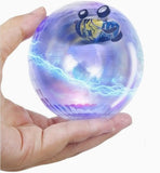 Hand holding a transparent ball with a car inside, glowing with colorful lights.