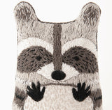 Embroidered patch of a raccoon face on a white background.