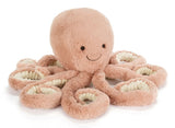 Plush peach colored octopus toy with a smiling face.