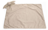 Beige blanket with a bunny on the top corner.