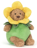 Brown plush teddy bear dressed in a yellow and green daffodil costume.