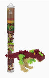 T-Rex building block set in a cylindrical tube with Plus Plus branding.