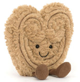 Heart-shaped beige plush toy with a smiling face.