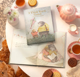 Book titled 'I Think You're Grand' on a table with teacups and cookies.