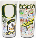 Front and rear view of the glass tumbler with University of Oregon logo, as well as a myriad of colorful illustrations of the campus, student life, and region.