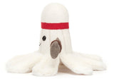 Side view of white plush toy badminton with a red headband, and gray arms, on a white background