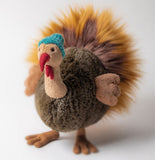 Plush brown turkey, with feathery textured fabric, wearing a blue knit cap.