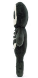 Skeleton plush toy with black and white design and a smiling face.