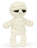 Plush white mummy toy with black eyes and a smiling face.