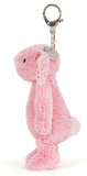 Pink plush bunny keychain with floral patterns on ears on a white background.