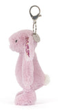 Pink bunny plush keychain with floral ears on a white background.