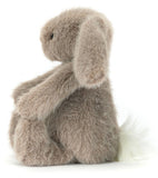 Plush brown toy rabbit with a white belly on a white background.