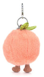 Plush peach-shaped keychain with a white background.