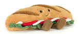 Plush toy shaped like a submarine sandwich with a smiling face on a white background.