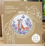 Embroidery kit packaging with fox design and 'hook, line & tinker' branding.