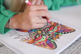 One of the markers in use, being used to fill in a coloring book page.