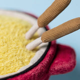 Close-up of plush red fondue pot.