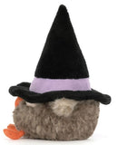 Gray plush toy owl wearing a large black witch hat with an orange feather tucked into the purple hatband.