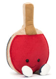Plush toy table tennis racquet with one gray side and one red side. it has a smiling face and little legs.