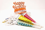 Colorful birthday noisemakers with 'Happy Birthday' tiara on a white background.
