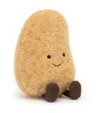 A plush toy resembling a potato with a smiling face, made from golden-brown fur fabric with corduroy legs.