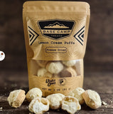 Bag of freeze-dried lemon cream puffs with 'Base Camp Treats' branding. A small window on the front of the bag provides a view of the candy.