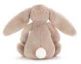A small beige plush bunny Rabbit with large floppy ears.