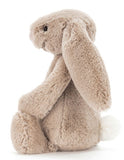 A small beige plush bunny Rabbit with large floppy ears.