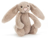 A small beige plush bunny Rabbit with large floppy ears.