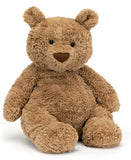 A large brown plush toy bear with a soft, fluffy texture in a sitting position.