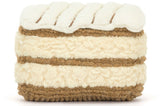 Stuffed animal resembling a beige layered cake.