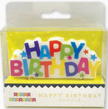 Colorful 'Happy Birthday' candle in packaging with 'Party Partners' branding.