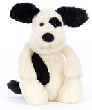 Plush toy dog with black and white pattern.