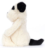 Plush toy dog with black and white pattern.