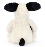 Plush toy dog with black and white pattern.