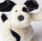 Plush toy dog with black and white pattern.