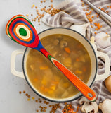 Pot of soup with a colorful spoon.