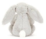 Gray plush bunny toy with large floppy ears, with floral fabric on ears and feet.