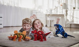 Two children playing with toy dinosaurs on a carpeted floor.
