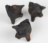 Three small terra cotta pig figurines 